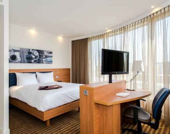 King suite with working station at the Hampton by Hilton Amsterdam Airport Schiphol.