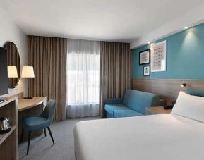 spacious king room with work and lounge area at Hampton by Hilton Torquay.