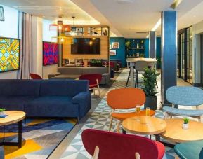 spacious and well lit lounge and coworking space at Hampton by Hilton London Park Royal.