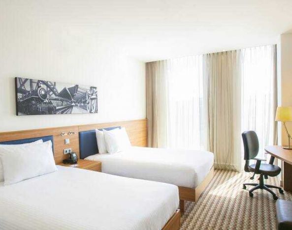 Twin room with working station at the Hampton by Hilton Amsterdam Arena Boulevard.