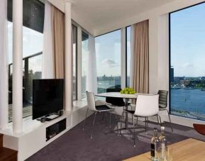 Bright living room overlooking the canals at the DoubleTree by Hilton Amsterdam Centraal Station.