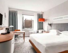 King bedroom with desk and TV screen at the Hilton Rotterdam.