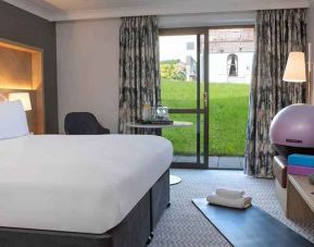 lovely king room with yoga and strateching equipment and garden view at Hilton Cobham.