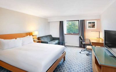 Spacious king room with TV, comfortable work desk and natural light at Hilton London Watford.