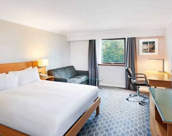 spacious king room with TV, comfortable work desk and natural light at Hilton London Watford.