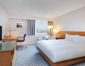 comfortable king room with TV and work desk at Hilton London Watford.
