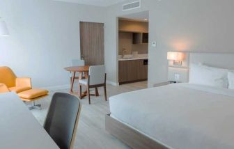 spacious king suite with work desk and lounge area at Hilton Garden Inn Santa Ana San Jose.