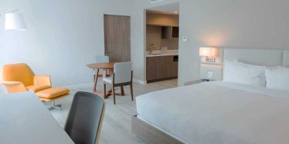 spacious king suite with work desk and lounge area at Hilton Garden Inn Santa Ana San Jose.