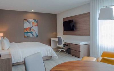 luxurious king suite with TV, work desk, and dining area at Hilton Garden Inn Santa Ana San Jose.