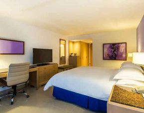 spacious king suite with TV and work desk at Hilton Cartagena Hotel.