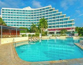 beautiful outdoor pool with sun beds at Hilton Cartagena Hotel.