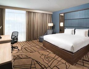 spacious king room with work desk and TV at Hilton Garden Inn Bogota Airport.