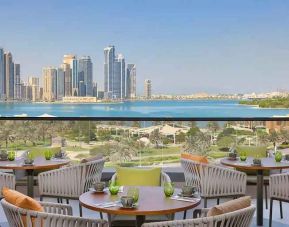 lovely outdoor terrace with gorgeous water/city views ideal as a coworking space at DoubleTree by Hilton Sharjah Waterfront Hotel & Residences.