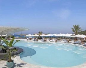 beautiful outdoor pool surrounded by seating and sun beds at Susona Bodrum, LXR Hotels & Resorts.