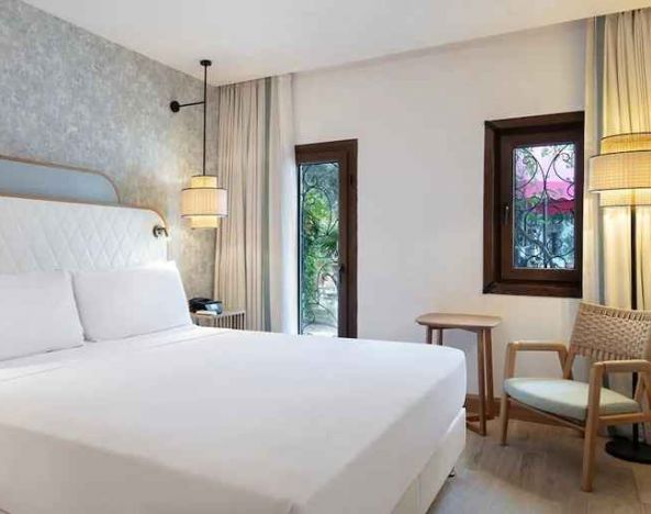 comfortable delux king room with TV and natural light at DoubleTree by Hilton Bodrum Marina Vista.