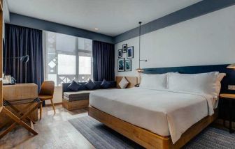 King guestroom with sofa and desk at the Hilton Garden inn Casablanca Sud.