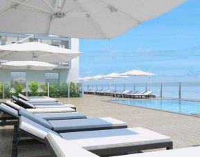 Relaxing outdoor pool area with lounges at the Hilton Garden inn Casablanca Sud.