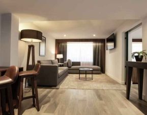 Large living room with working station at the Hotel 1970 Guadalajara, Curio Collection by Hilton.