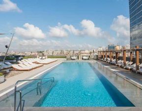 stunning outdoor pool with sun beds at Hilton Istanbul Bomonti Hotel & Conference Center.