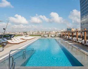 stunning outdoor pool with sun beds at Hilton Istanbul Bomonti Hotel & Conference Center.