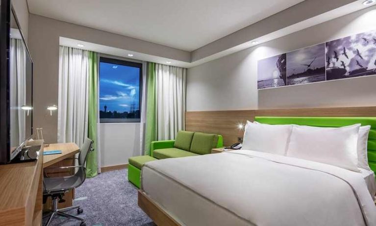 colourful king room with work desk and TV at Hampton by Hilton Istanbul Zeytinburnu.