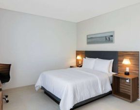Hotel room with desk and queen size bed at the Hampton Inn by Hilton Cancun Cumbres.