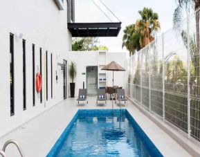 Relaxing outdoor pool at the Hampton Inn by Hilton Cancun Cumbres.