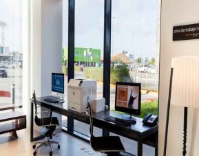 Working station with computers and printer at the Hampton Inn by Hilton Cancun Cumbres.