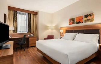 spacious king room with work desk and TV at Hilton Garden Inn Sevilla.