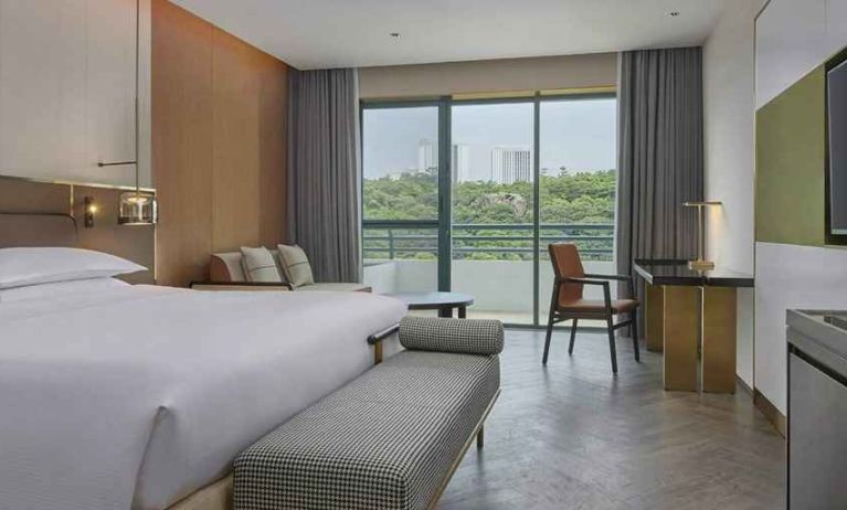 spacious king bedroom with desk, chair, and lounge suite at Hilton Guangzhou Science City.