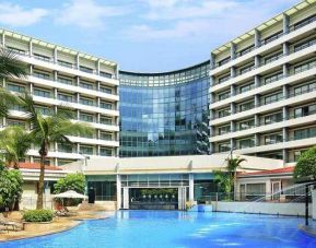 stunning outdoor pool with sunbeds at Hilton Guangzhou Science City.