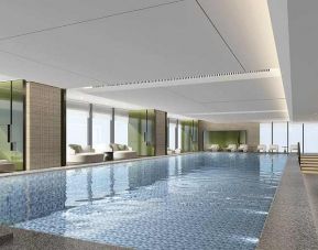 beautiful indoor pool large enough to do laps, surrounded by sun beds at DoubleTree by Hilton Kunming Airport.