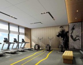 well equipped fitness center with lots of natural light at DoubleTree by Hilton Kunming Airport.