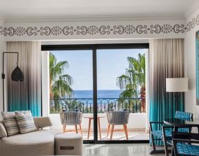 Living room with balcony perfect as workspace at the Hilton Los Cabos Beach & Golf Resort.