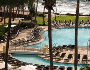 Relaxing outdoor pool area with lounges at the Caribe Hilton.
