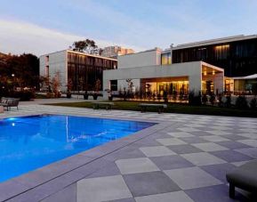 Relaxing outdoor pool at the Boeira Garden Hotel Porto Gaia, Curio Collection by Hilton.