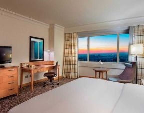 lovely king bedroom with TV, desk, and chair at Adana HiltonSA.