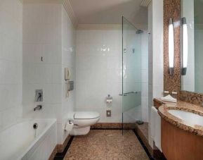 spacious bathroom with bath and shower at Adana HiltonSA.