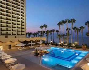 stunning outdoor pool with sun beds and seating area at Mersin HiltonSA.