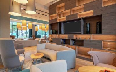 Hotel workspace with sofas and TV screen at the Hampton by Hilton Warsaw Mokotow.