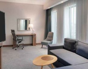 Living room with working station at the Hampton by Hilton Warsaw Mokotow.