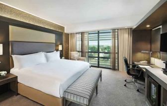 King bedroom with desk at the Legend Hotel Lagos Airport, Curio Collection by Hilton.