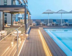 Outdoor pool area with lounges at the Hilton Garden Inn Umhlanga Arch.