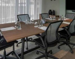 Meeting room with small table and TV screen at the Hilton Garden Inn Umhlanga Arch.