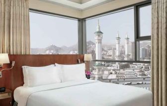 Hotel room with large windows and view at the Hilton Suites Makkah.