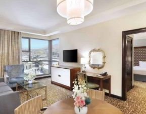 Living room with working station at the Hilton Suites Makkah.