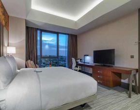 spacious king room with TV, work desk, chair, and couch at Hilton Garden Inn Istanbul Ataturk Airport.