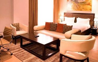 luxurious king suite with lounge area, business desk, and chair at DoubleTree by Hilton Nairobi Hurlingham.