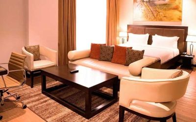luxurious king suite with lounge area, business desk, and chair at DoubleTree by Hilton Nairobi Hurlingham.
