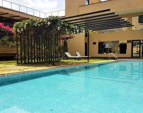 lovely outdoor pool with sun beds at DoubleTree by Hilton Nairobi Hurlingham.